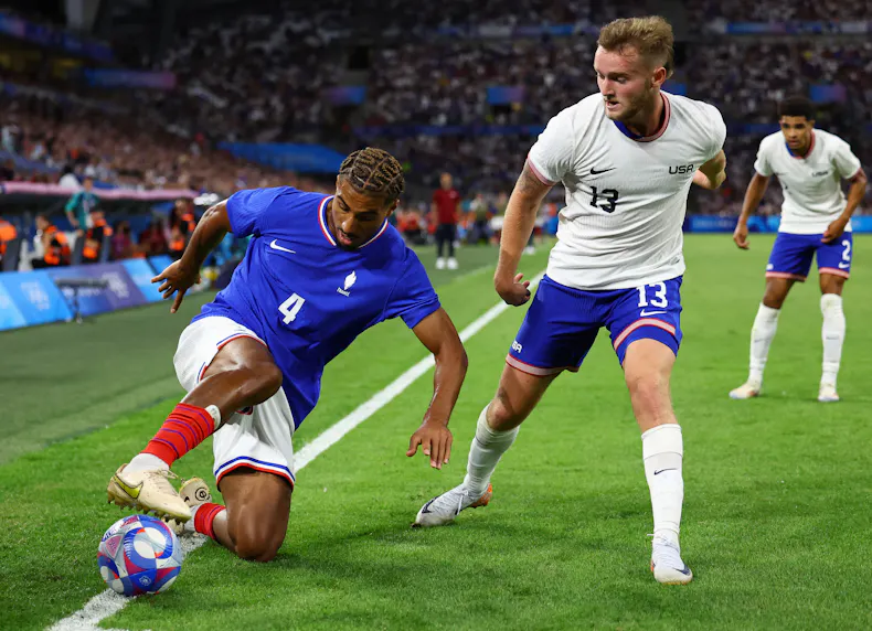 France's Loic Bade in action against the USA's Duncan McGuire as we dive into the best bets and predictions for the Olympic soccer clash between New Zealand and the USA.