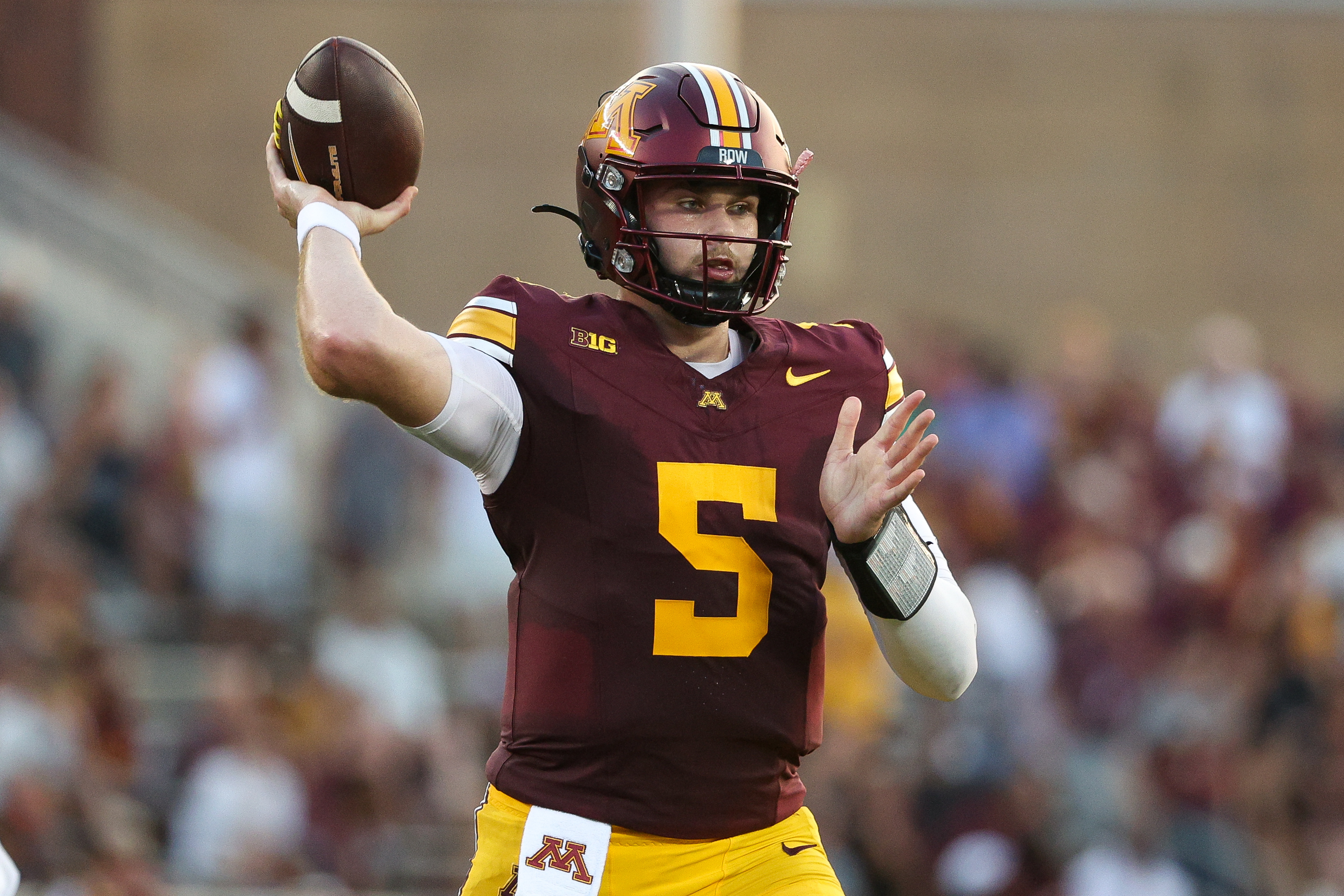 Minnesota Golden Gophers quarterback Drake Lindsey (5) throws the ball as we break down our Minnesota vs. Washington prediction.