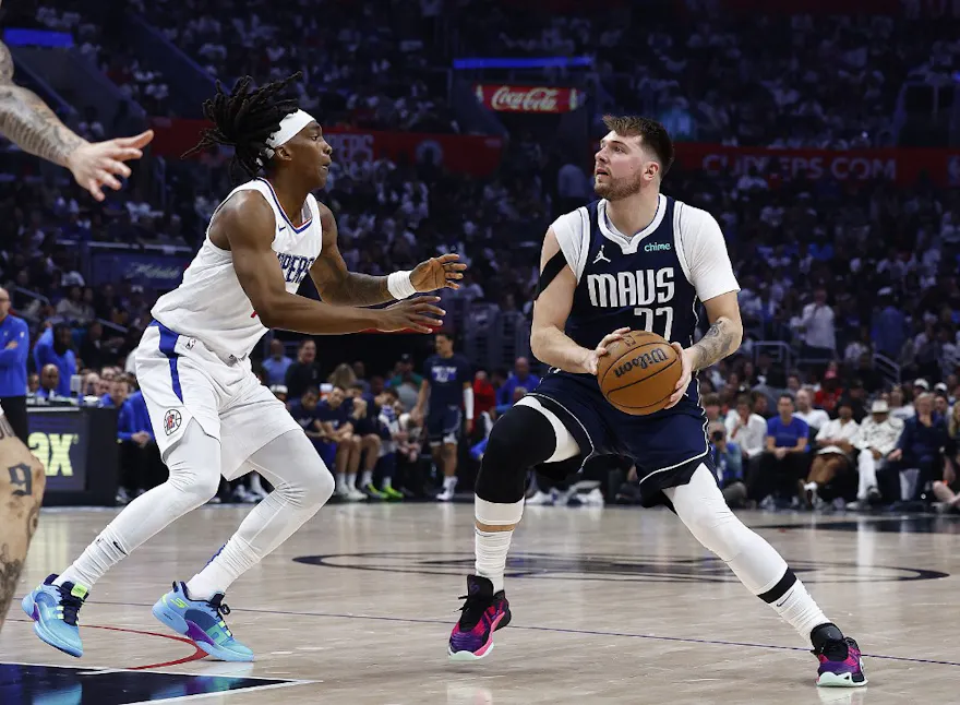 Luka Doncic of the Dallas Mavericks and Terance Mann of the LA Clippers during Game 5 of the Western Conference playoffs. We're backing Doncic in our Clippers vs. Mavericks player props. 