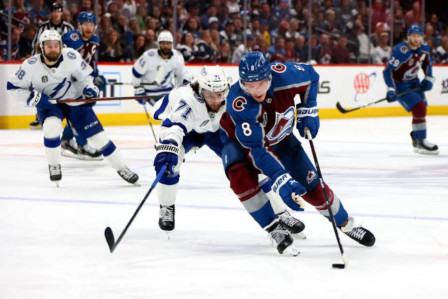 Cale Makar of the Colorado Avalanche carries the puck in front of Anthony Cirelli of the Tampa Bay Lightning.