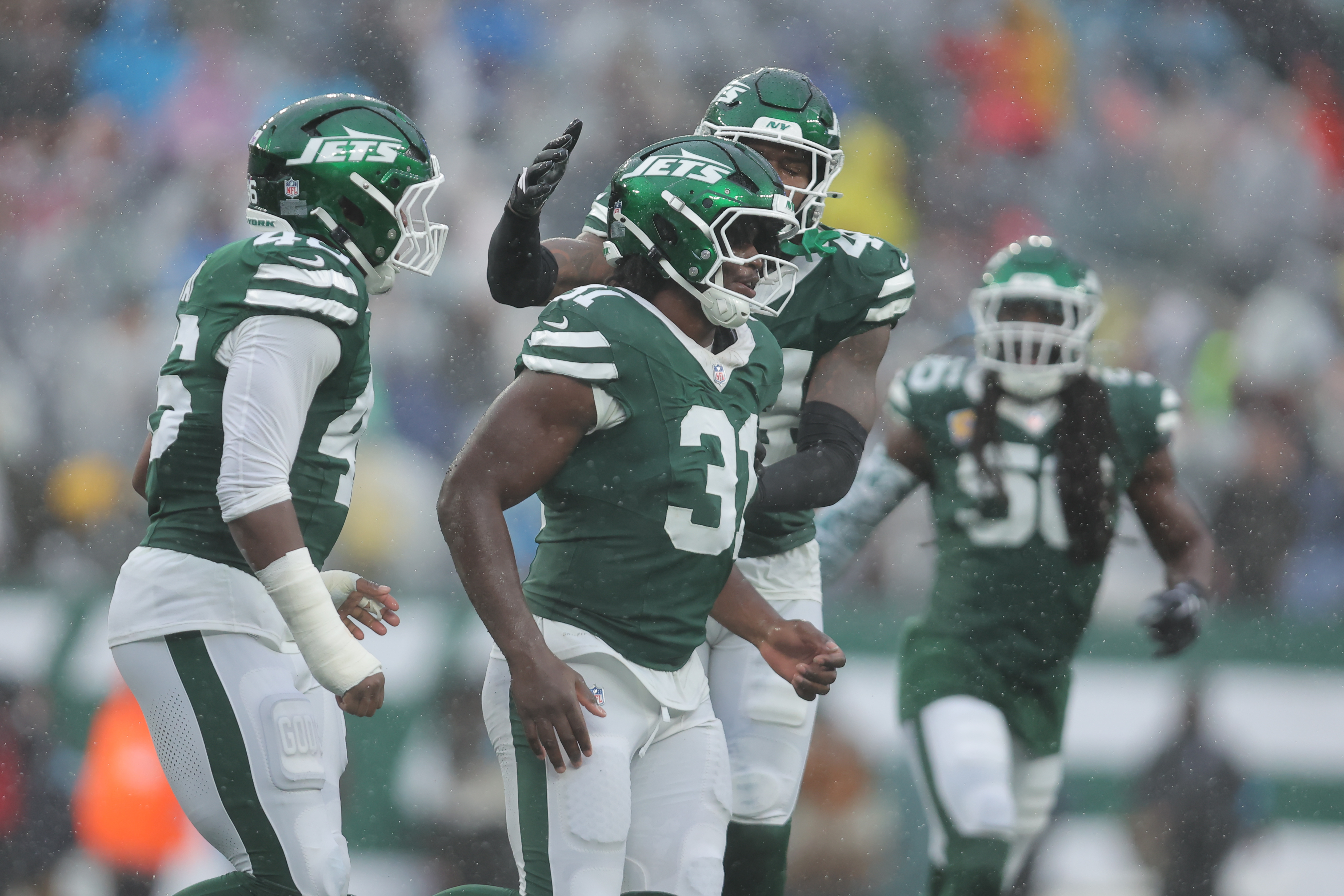 New York Jets linebacker Jamien Sherwood (44) and New York Jets defensive end Joseph Ossai (46) celebrate with defensive end David Bailey (31) as we look at the NFL Defensive Rookie of the Year odds.