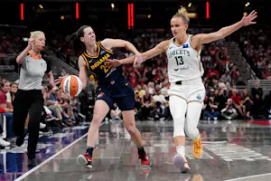 Caitlin Clark (22) of the Indiana Fever dribbles the ball while being fouled by Leonie Fiebich (13) of the New York Liberty, as we offer our best Fever vs. Liberty predictions for Saturday's game at Barclays Center in Brooklyn, N.Y.