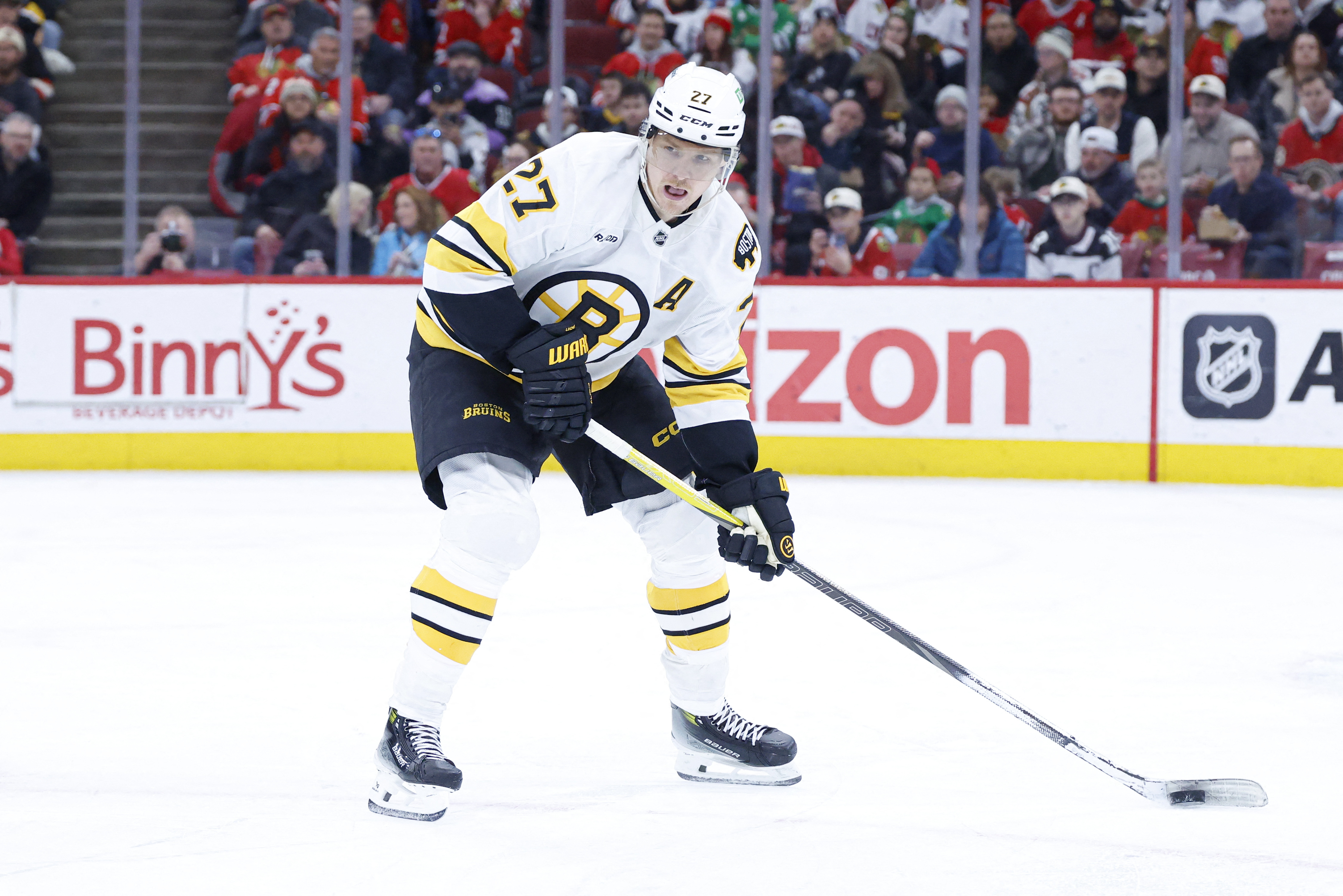 Boston Bruins defenseman Hampus Lindholm looks to pass the puck as we look at Massachusetts blocking Kalshi.