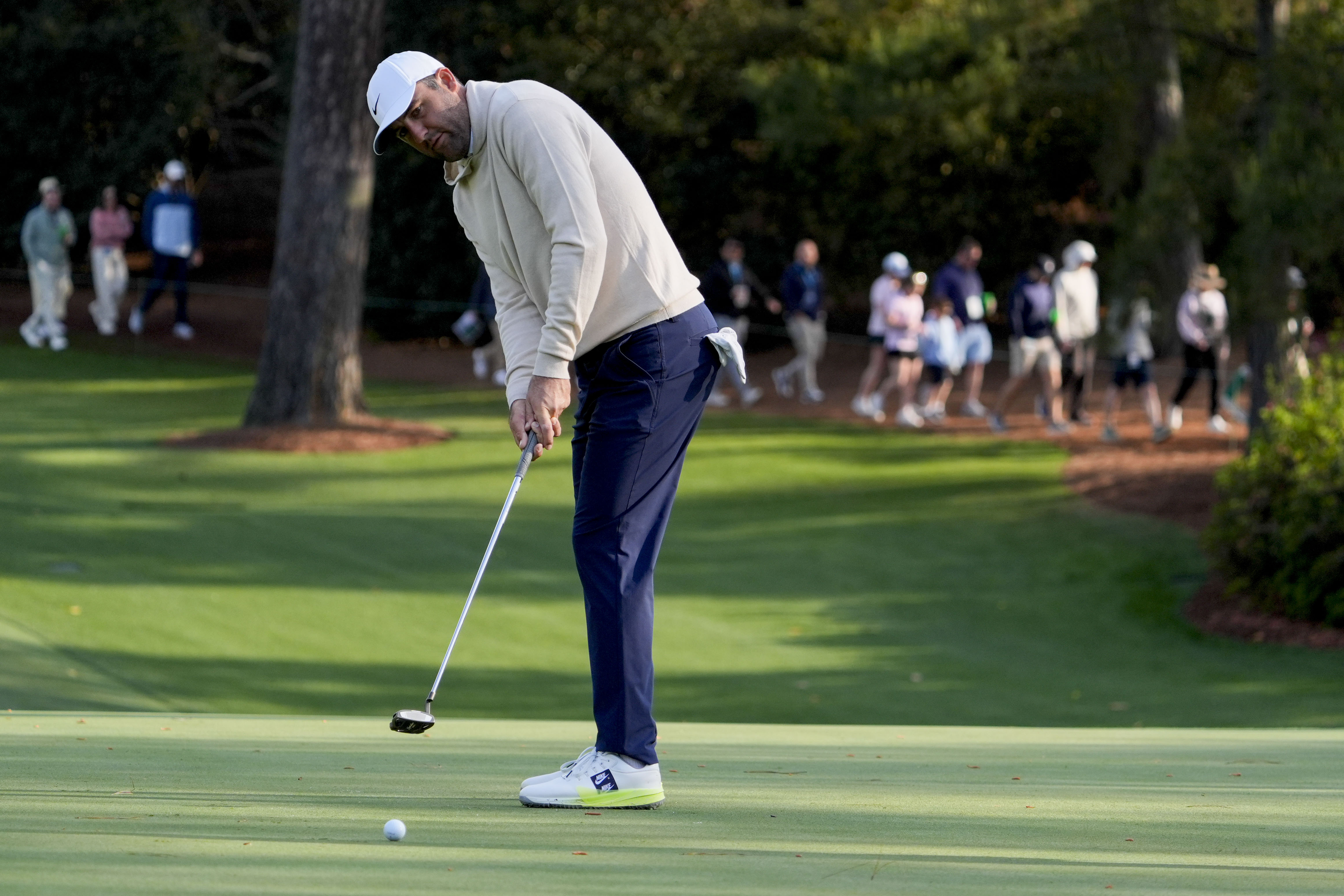 Scottie Scheffler putts on the 10th green during a practice round for the Masters Tournament at Augusta National Golf Club.