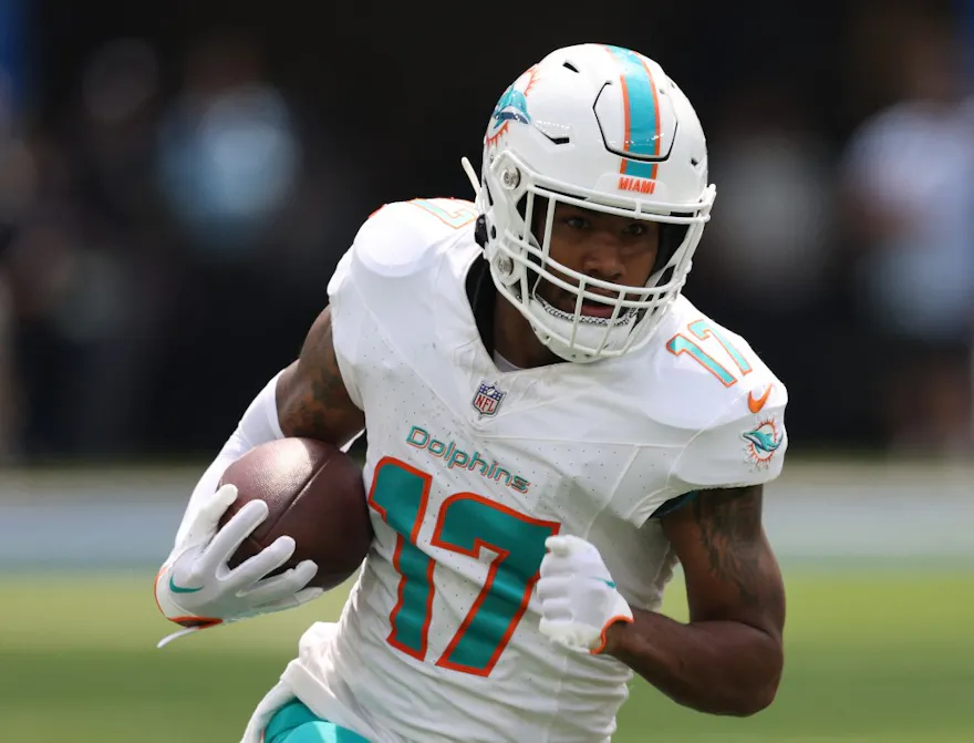 Jaylen Waddle of the Miami Dolphins runs after his catch at SoFi Stadium, and we offer new U.S. bettors our exclusive Caesars promo code.