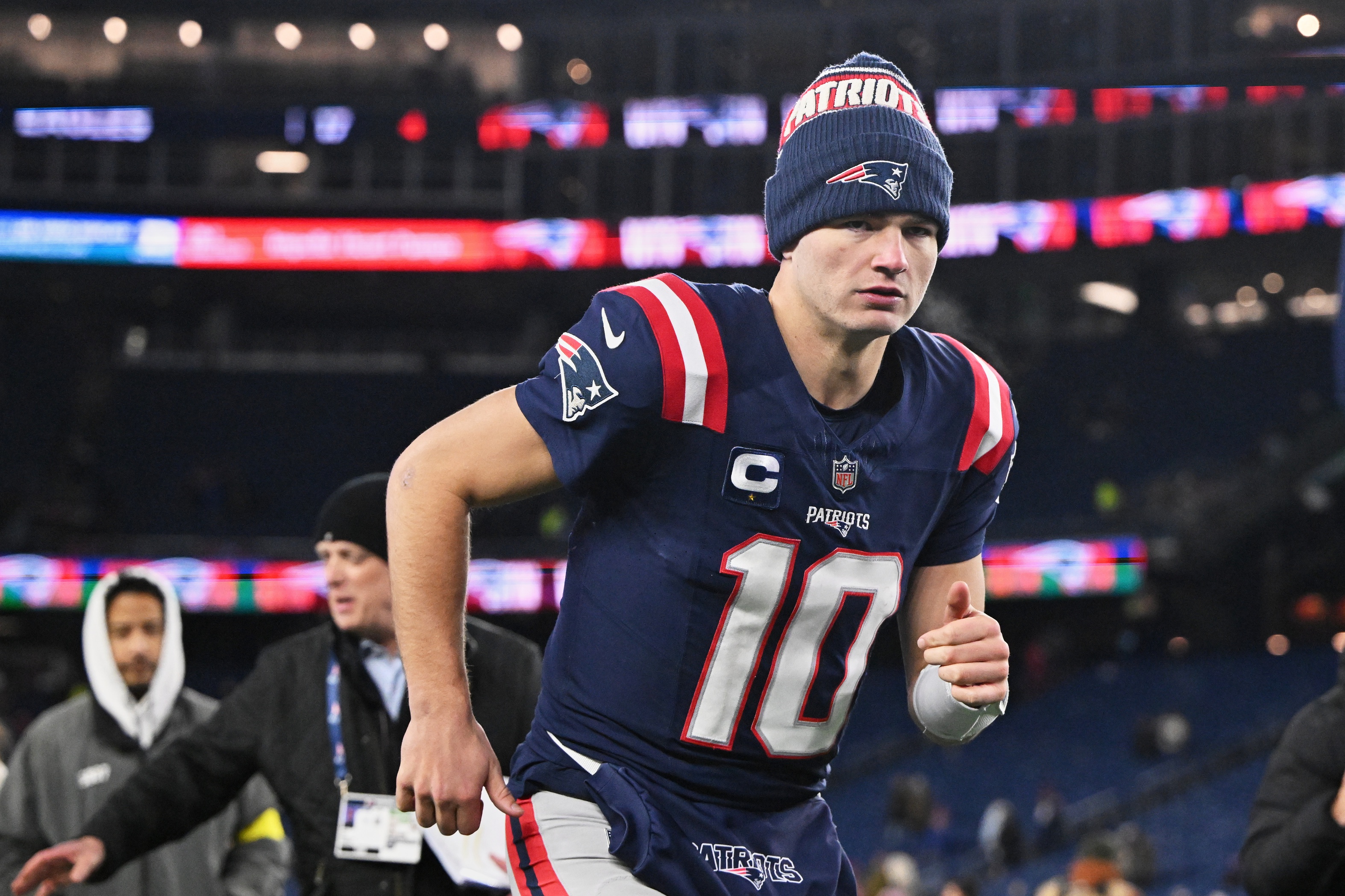  New England Patriots quarterback Drake Maye runs off the field, and he's key as we look at the NFL divisional round look-ahead odds.