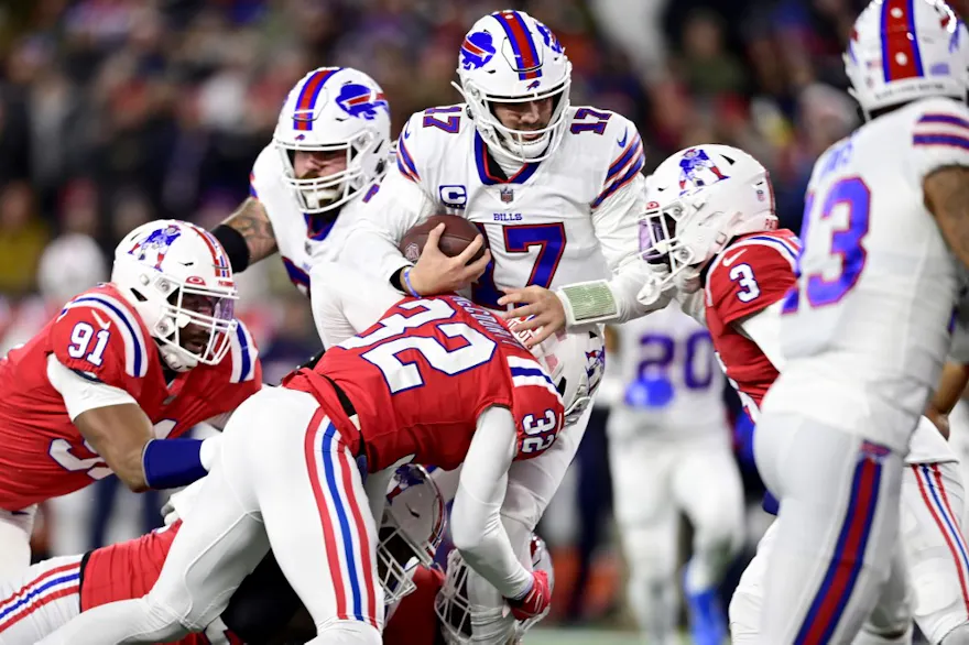 Quarterback Josh Allen #17 of the Buffalo Bills is tackled by safety Devin McCourty #32 of the New England Patriots in the first half at Gillette Stadium on Dec. 1, 2022.