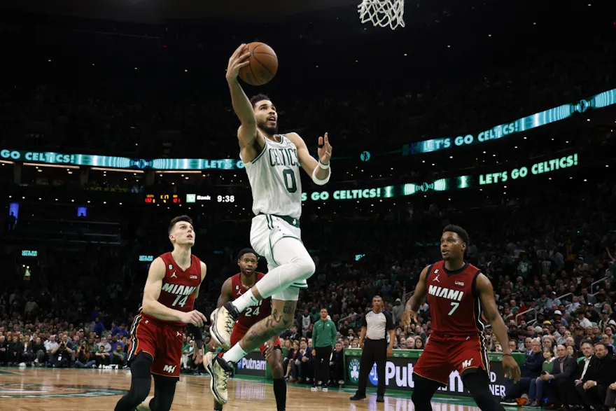 Jayson Tatum of the Boston Celtics goes to the basket as Tyler Herro of the Miami Heat and Kyle Lowry look on during the second half at TD Garden on November 30, 2022 in Boston, Massachusetts.