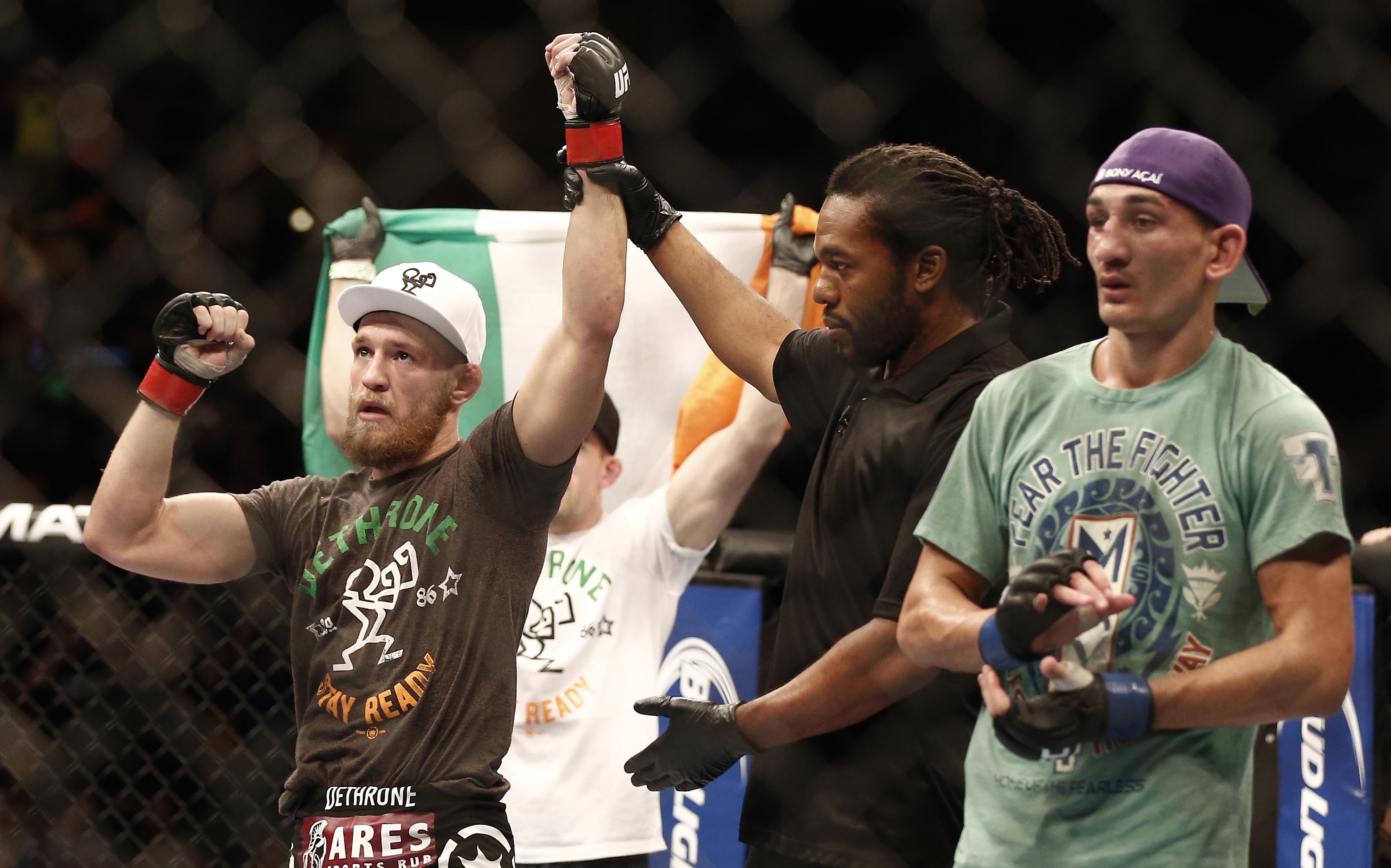Conor McGregor celebrates his win over Max Holloway as we look at the McGregor vs. Holloway 2 odds.
