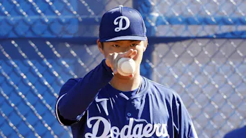 Yoshinobu Yamamoto of the Los Angeles Dodgers pitches during workouts, and we offer our look at the top MLB Rookie of the Year odds.