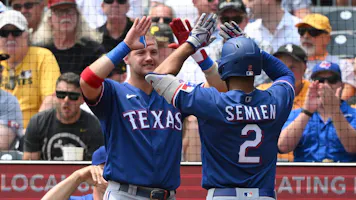 Marcus Semien of the Texas Rangers is met at the dugout by Josh Jung after hitting a solo home run in the first inning during the game against the Pittsburgh Pirates as we look at our 2023 World Series odds.