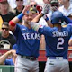 Marcus Semien of the Texas Rangers is met at the dugout by Josh Jung after hitting a solo home run in the first inning during the game against the Pittsburgh Pirates as we look at our 2023 World Series odds.