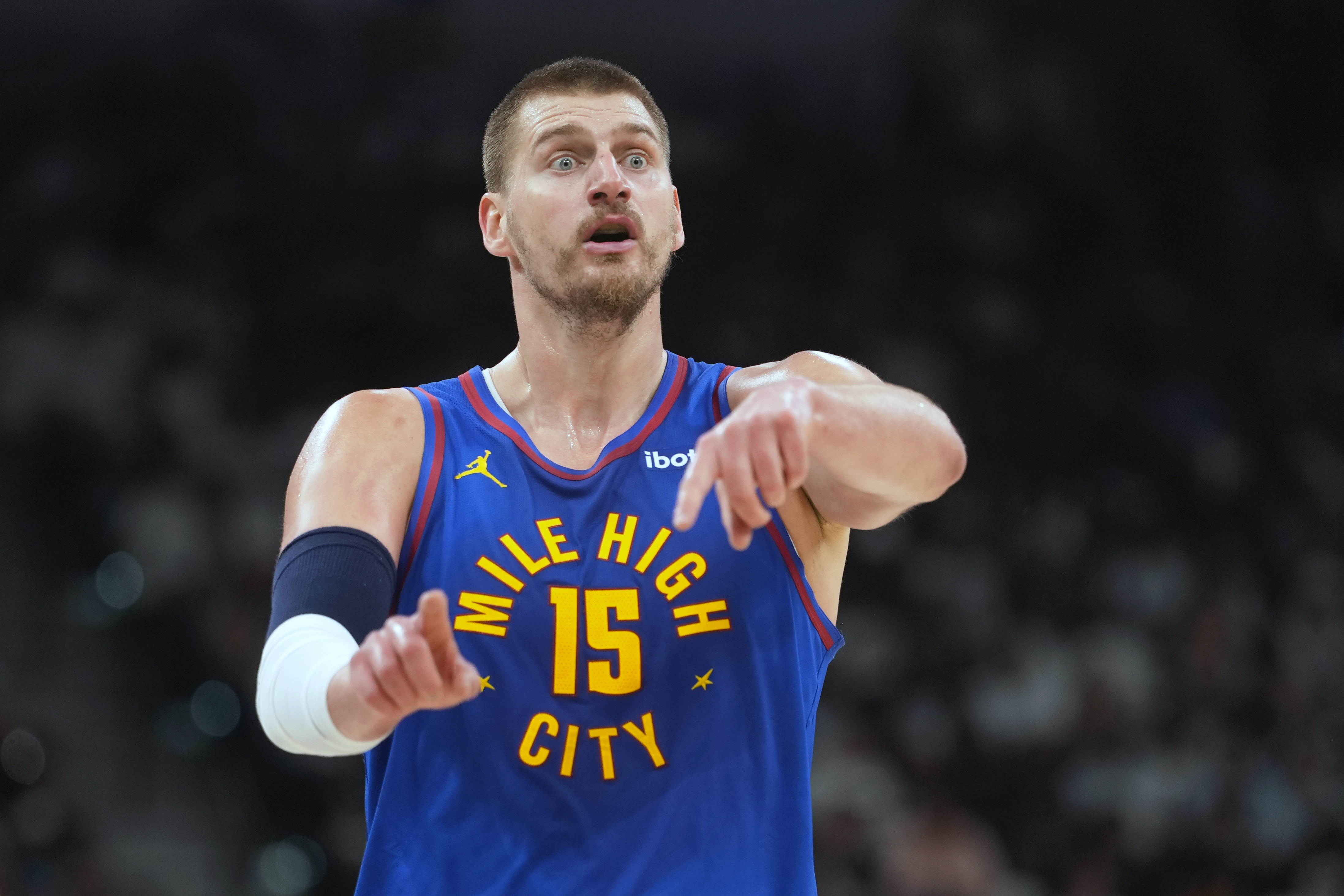 Denver Nuggets center Nikola Jokic (15), seen here signaling to teammates during a game, is featured in our 2026 NBA awards eligibility tracker.