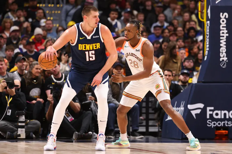Nikola Jokic #15 of the Denver Nuggets is defended by Charles Bassey #28 of the San Antonio Spurs as we make our Nuggets vs. Spurs prediction and pick.