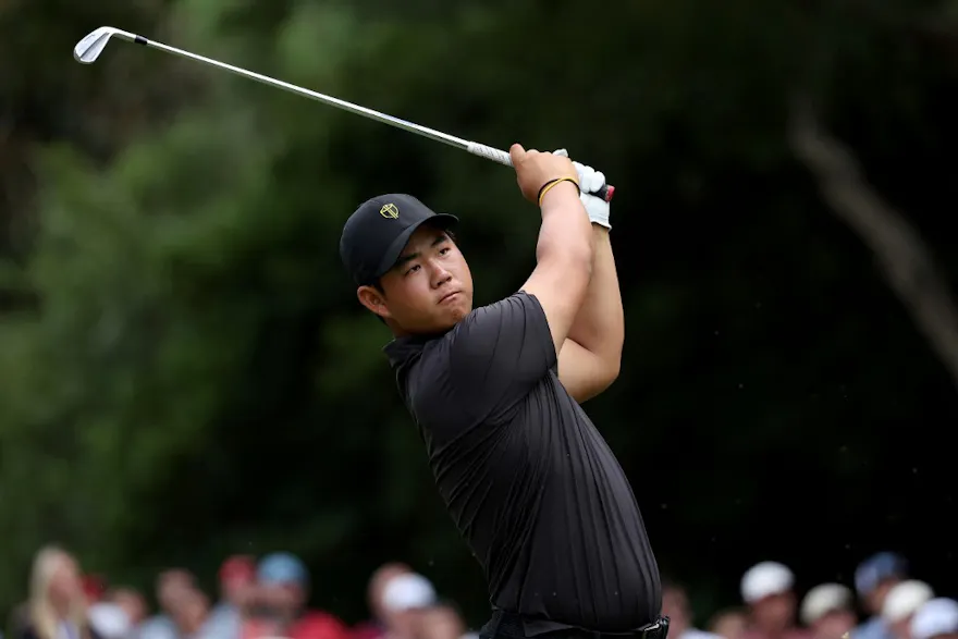 Tom Kim of South Korea and the International Team plays his shot from the sixth tee during Sunday singles matches on day four of the 2022 Presidents Cup at Quail Hollow Country Club on September 25, 2022 in Charlotte, North Carolina.