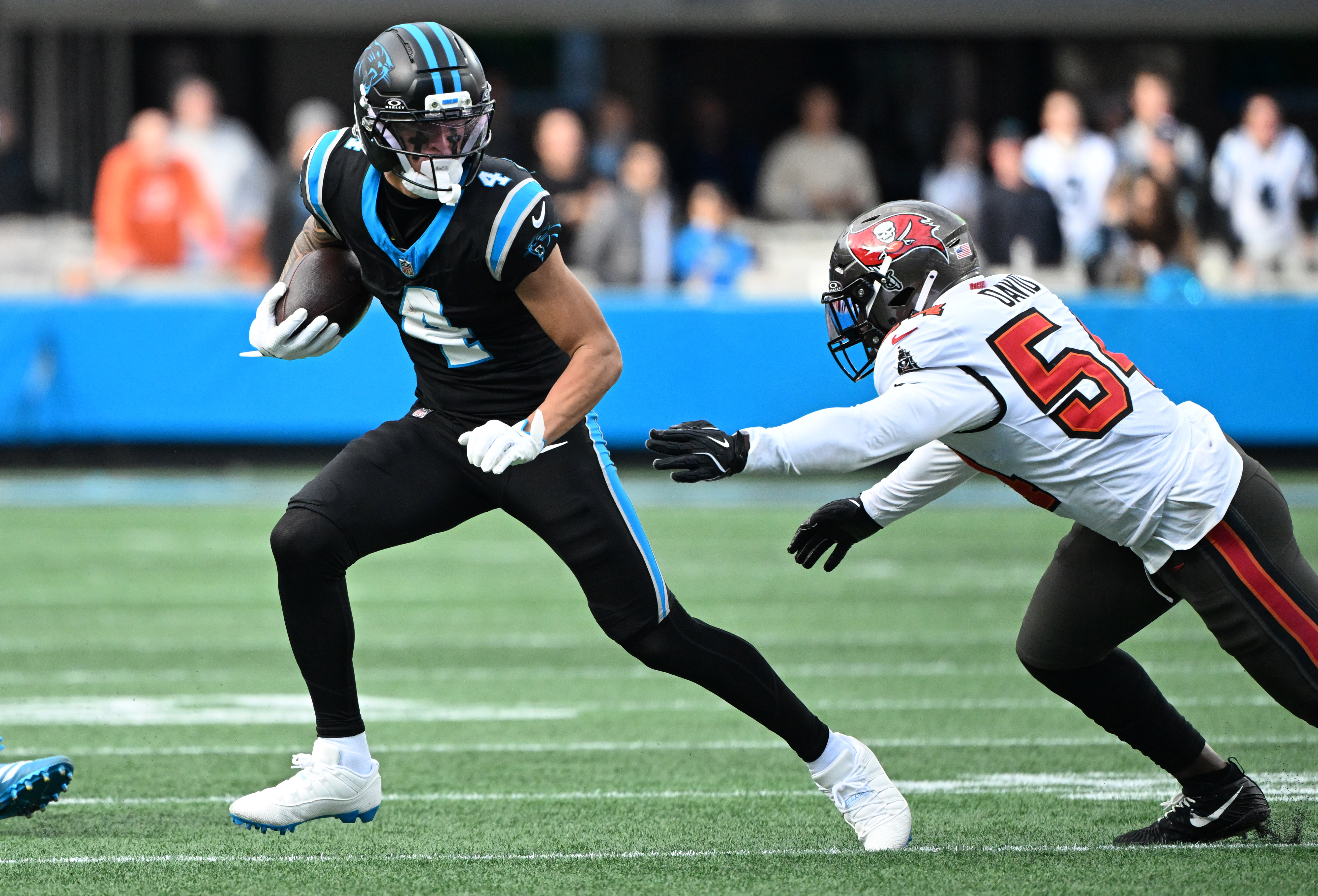 Carolina Panthers wide receiver Tetairoa McMillan (4) runs with the ball as we break down the NFL Offensive Rookie of the Year odds.