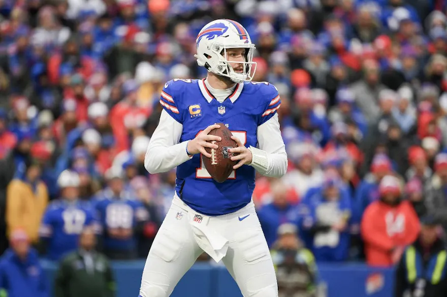Josh Allen of the Buffalo Bills looks to pass as we look at New York setting a weekly revenue record during Super Wild Card Weekend.