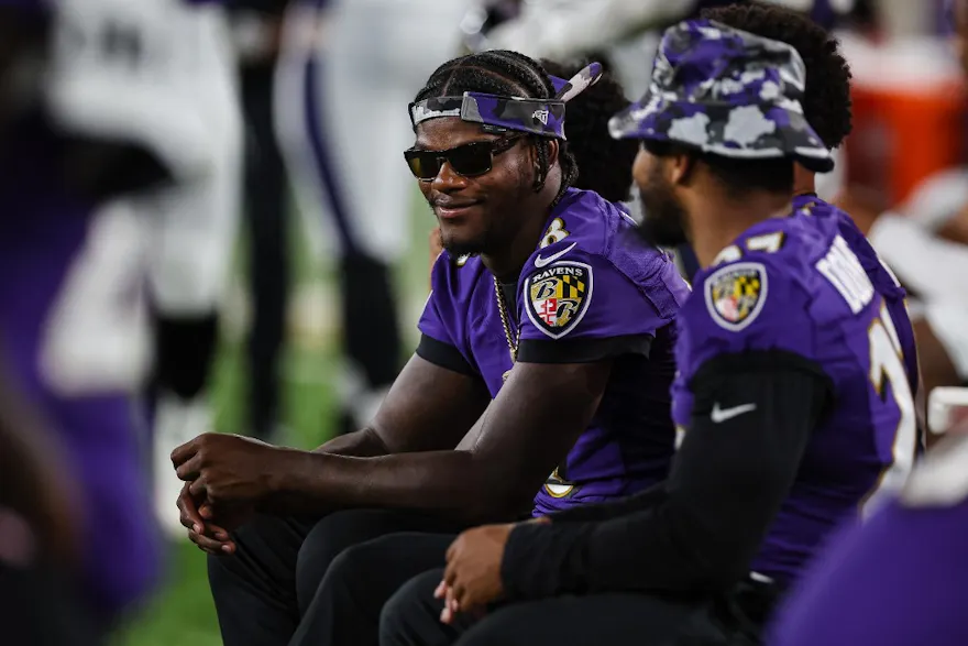 Lamar Jackson of the Baltimore Ravens looks on from the sidelines against the Washington Commanders.