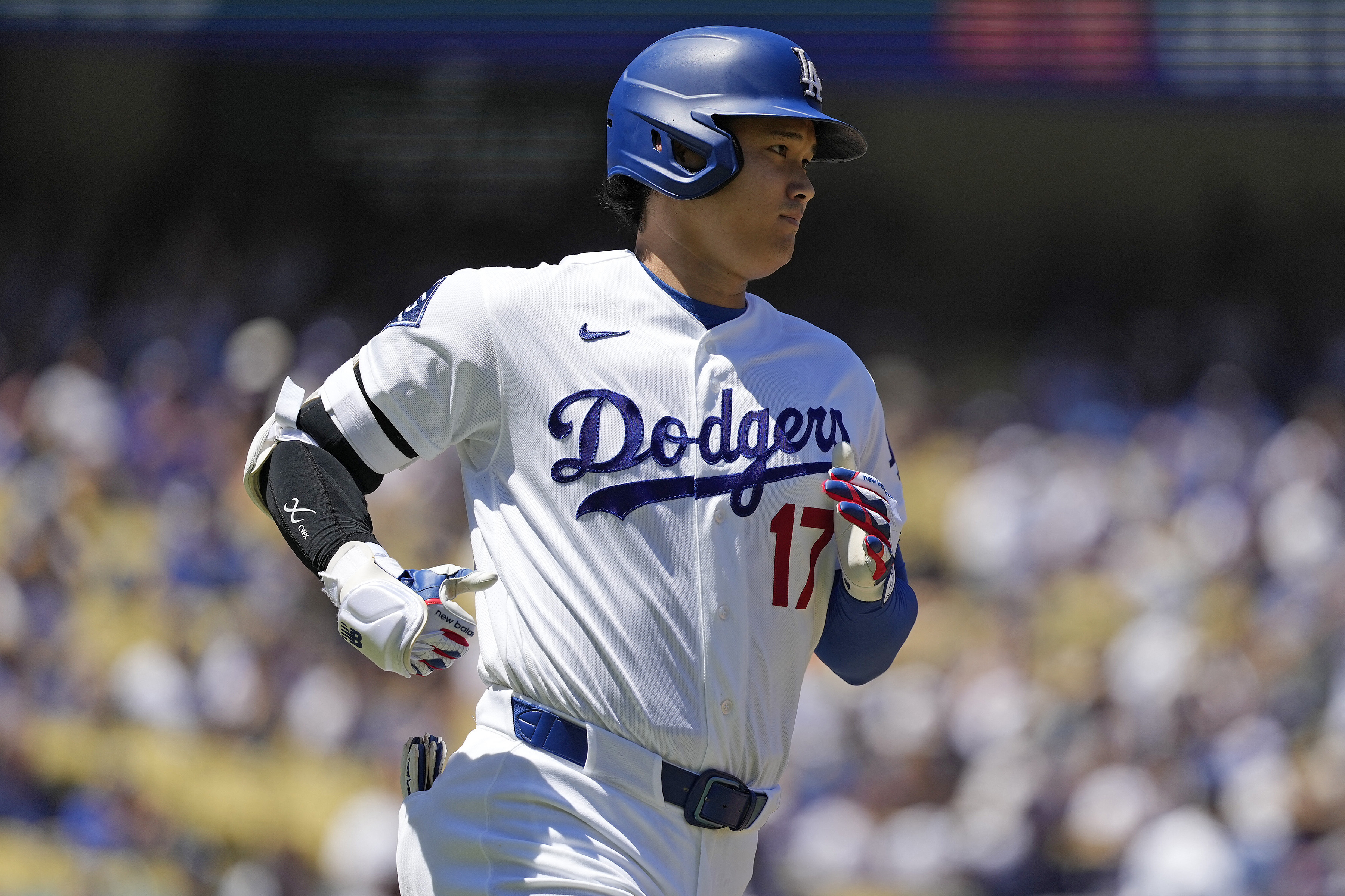 Los Angeles Dodgers two-way player Shohei Ohtani (17) hits a single as he is featured in our home run predictions.