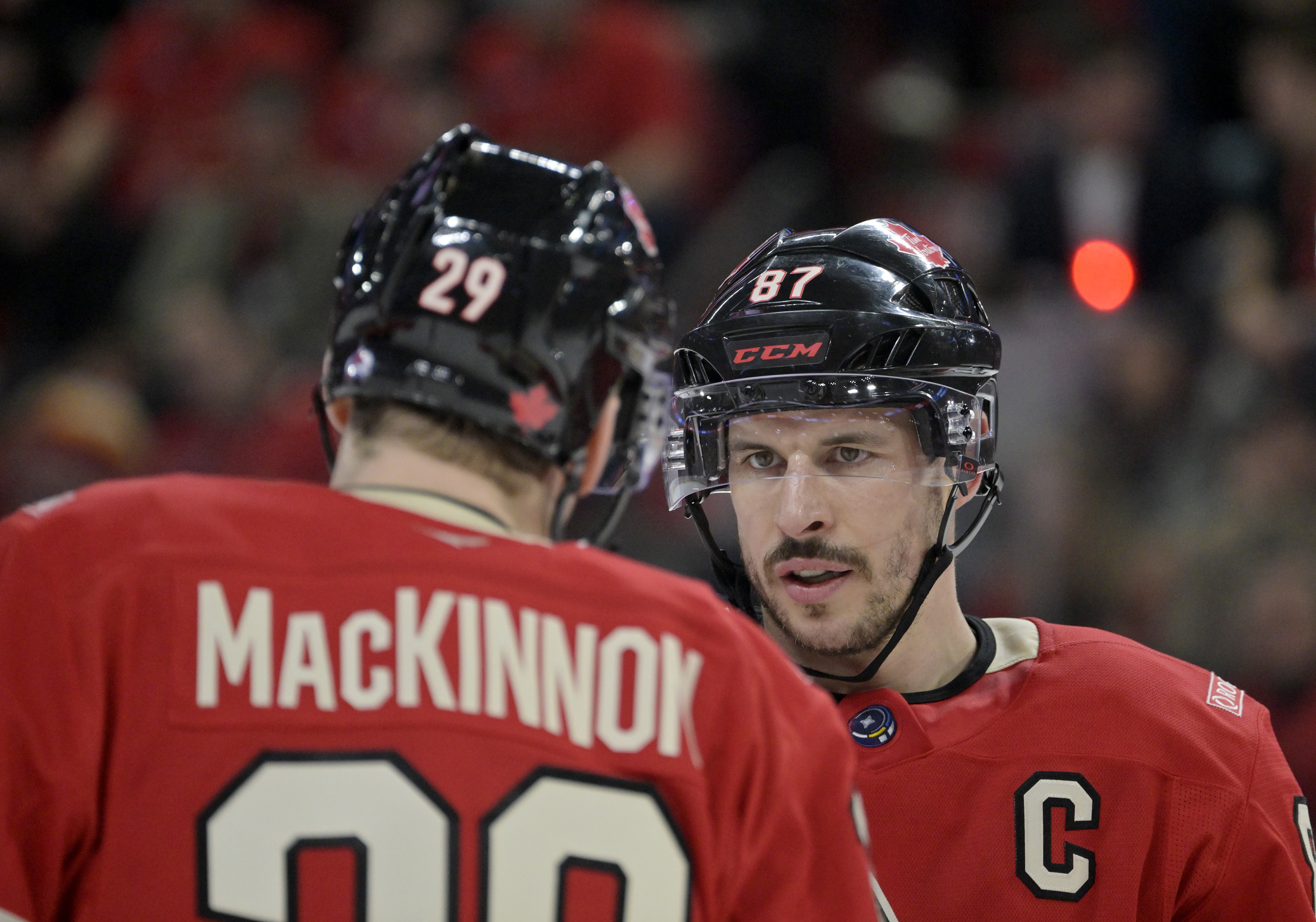 Team Canada forward Nathan MacKinnon (29) and teammate forward Sidney Crosby (87) prepare for a face-off against Team United States. 