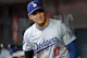 Shohei Ohtani of the Los Angeles Dodgers stands in the dugout as we look at our best Dodgers vs. Reds Player Props & Expert Picks