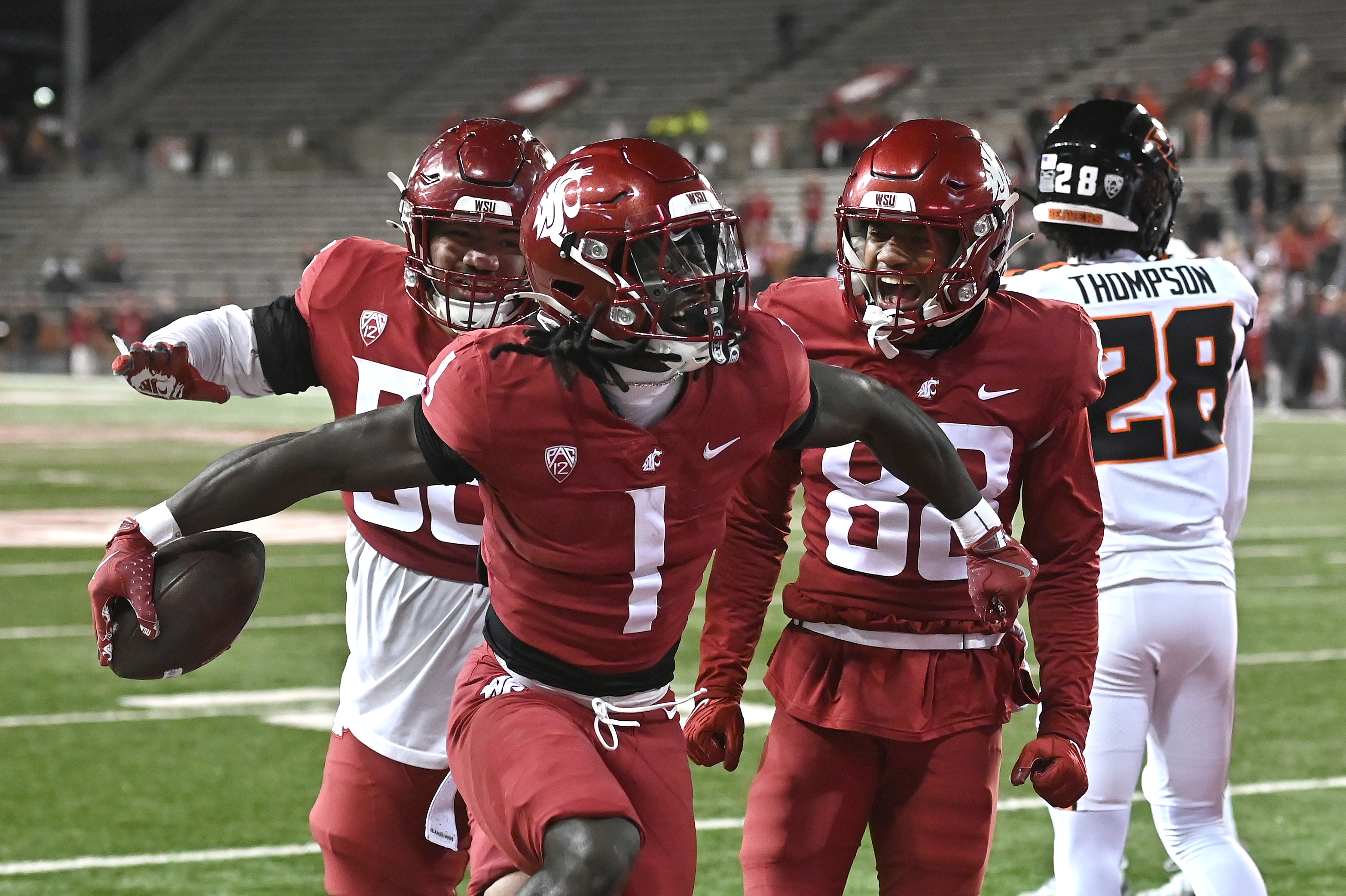 Washington State running back Angel Johnson (1) celebrates a touchdown as we track our college football bowl game predictions