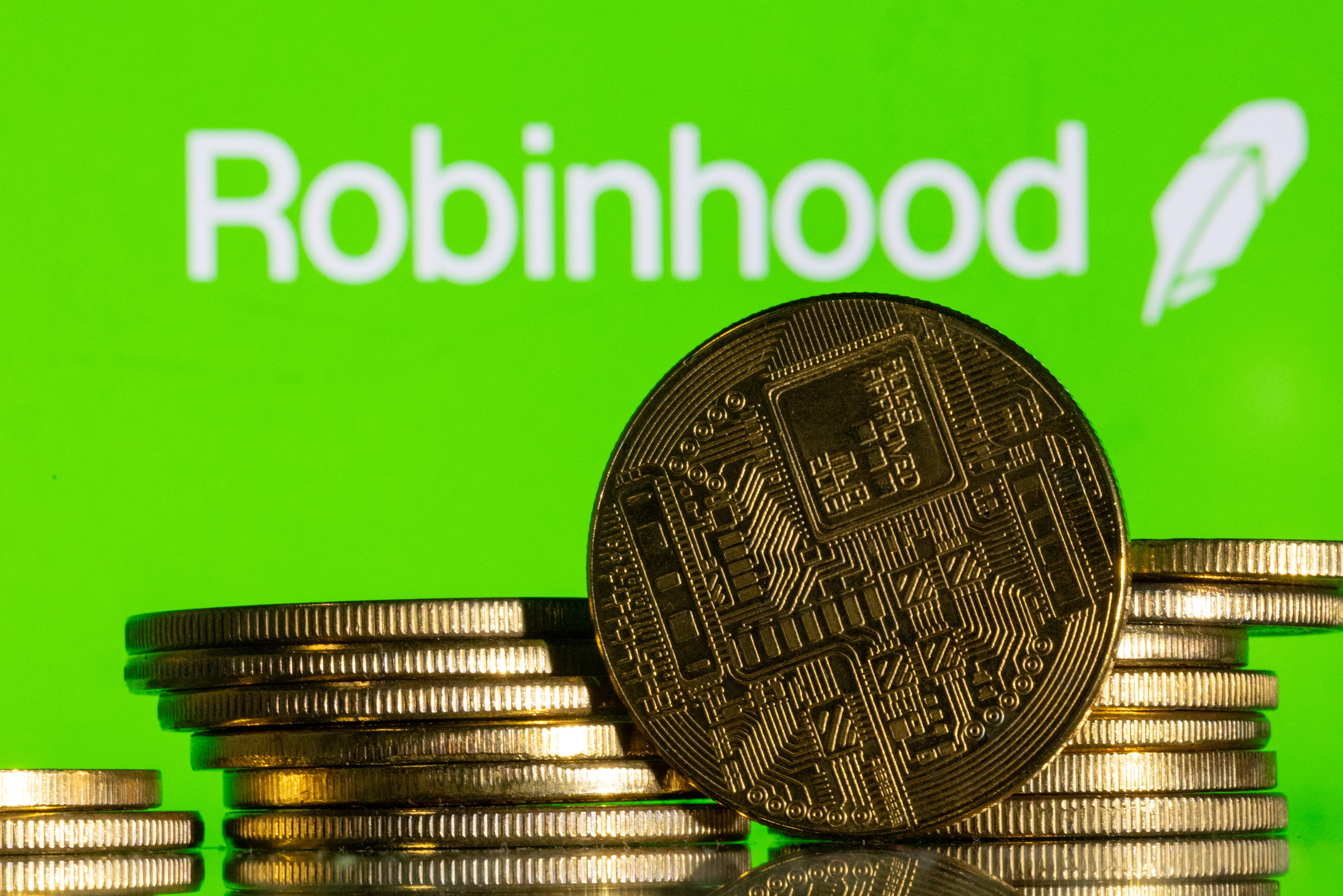 Robinhood logo and representations of cryptocurrency are seen in this illustration as we look at its "custom combos" predictions.