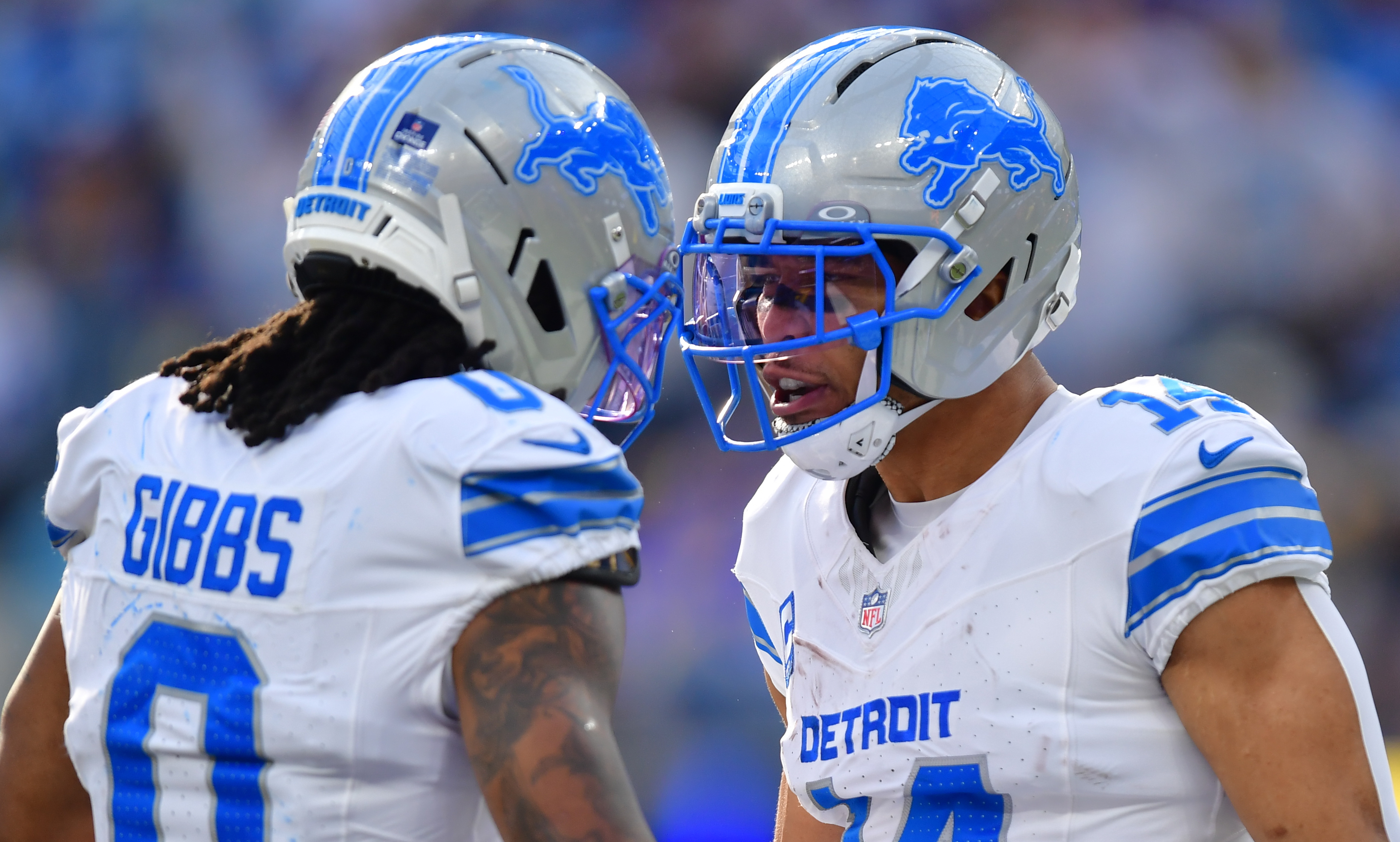 Detroit Lions running back Jahmyr Gibbs (0) and wide receiver Amon-Ra St. Brown (14) celebrate as we offer our Lions vs. Vikings predictions.