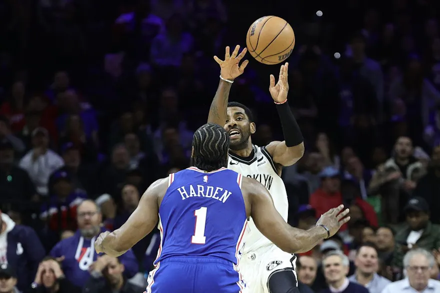 Kyrie Irving of the Brooklyn Nets passes over James Harden of the Philadelphia 76ers at Wells Fargo Center on Jan. 25, 2023 in Philadelphia, Pennsylvania.
