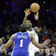 Kyrie Irving of the Brooklyn Nets passes over James Harden of the Philadelphia 76ers at Wells Fargo Center on Jan. 25, 2023 in Philadelphia, Pennsylvania.