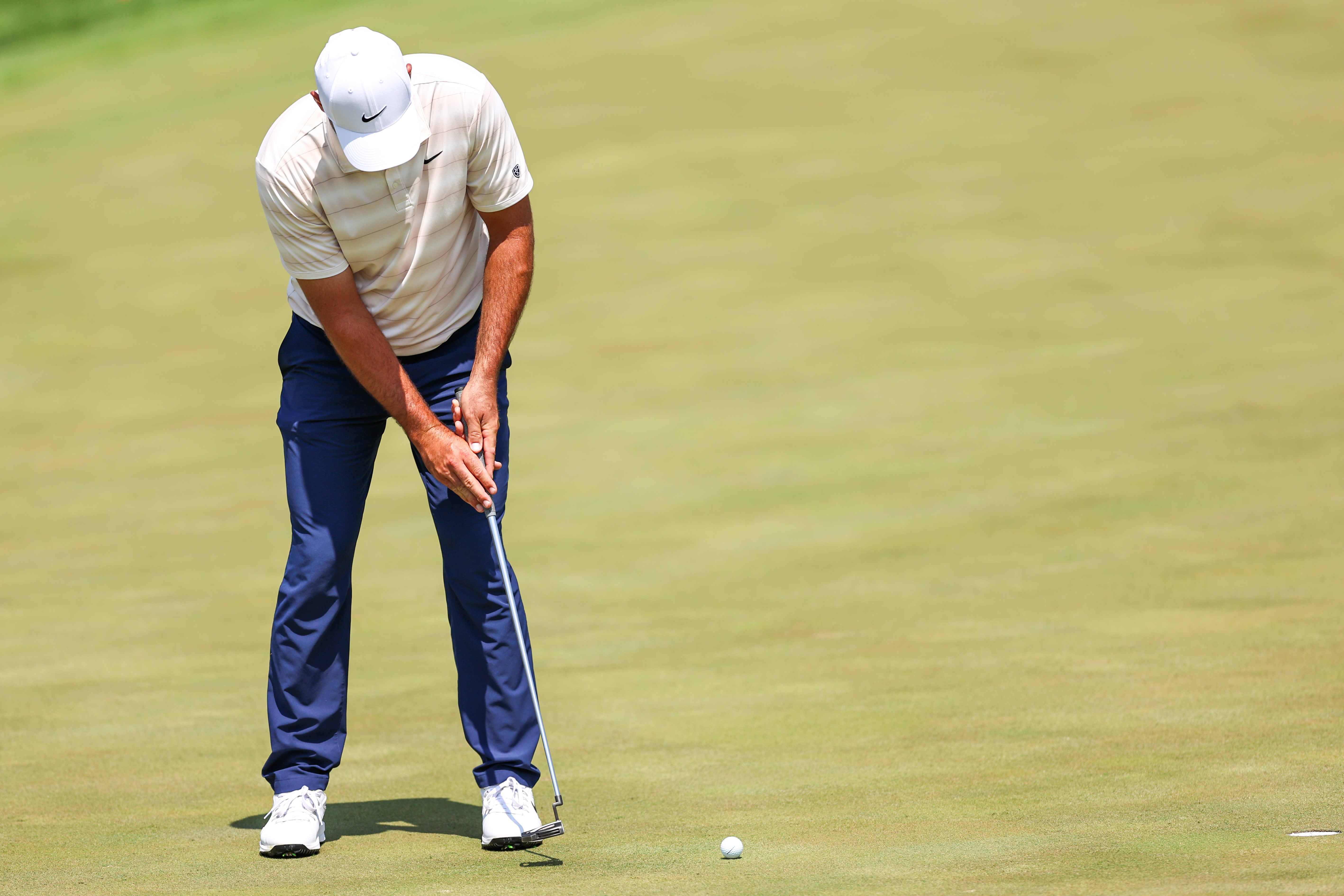 Scottie Scheffler of the United States putts as he is featured in our 3M Open Second-Round Leader prediction & odds.