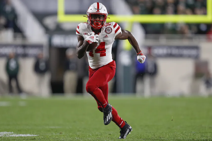 Nebraska Cornhuskers running back Rahmir Johnson runs with the ball during the second quarter against the Michigan State Spartans as we look at our college football parlay picks.