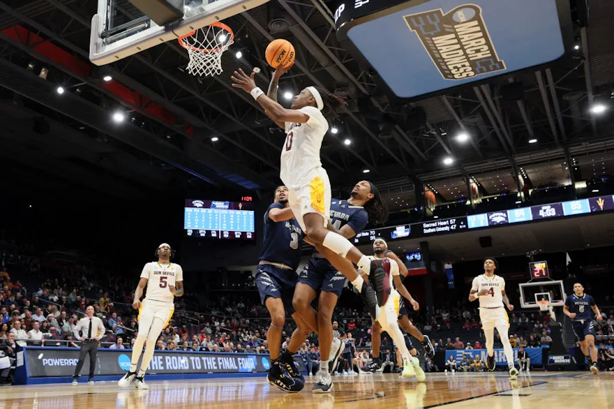 DJ Horne of the Arizona State Sun Devils shoots against Trey Pettigrew and Tre Coleman of the Nevada Wolf Pack during the First Four game of the NCAA Men's Basketball Tournament at University of Dayton Arena on Mar. 15, 2023 in Dayton, Ohio.