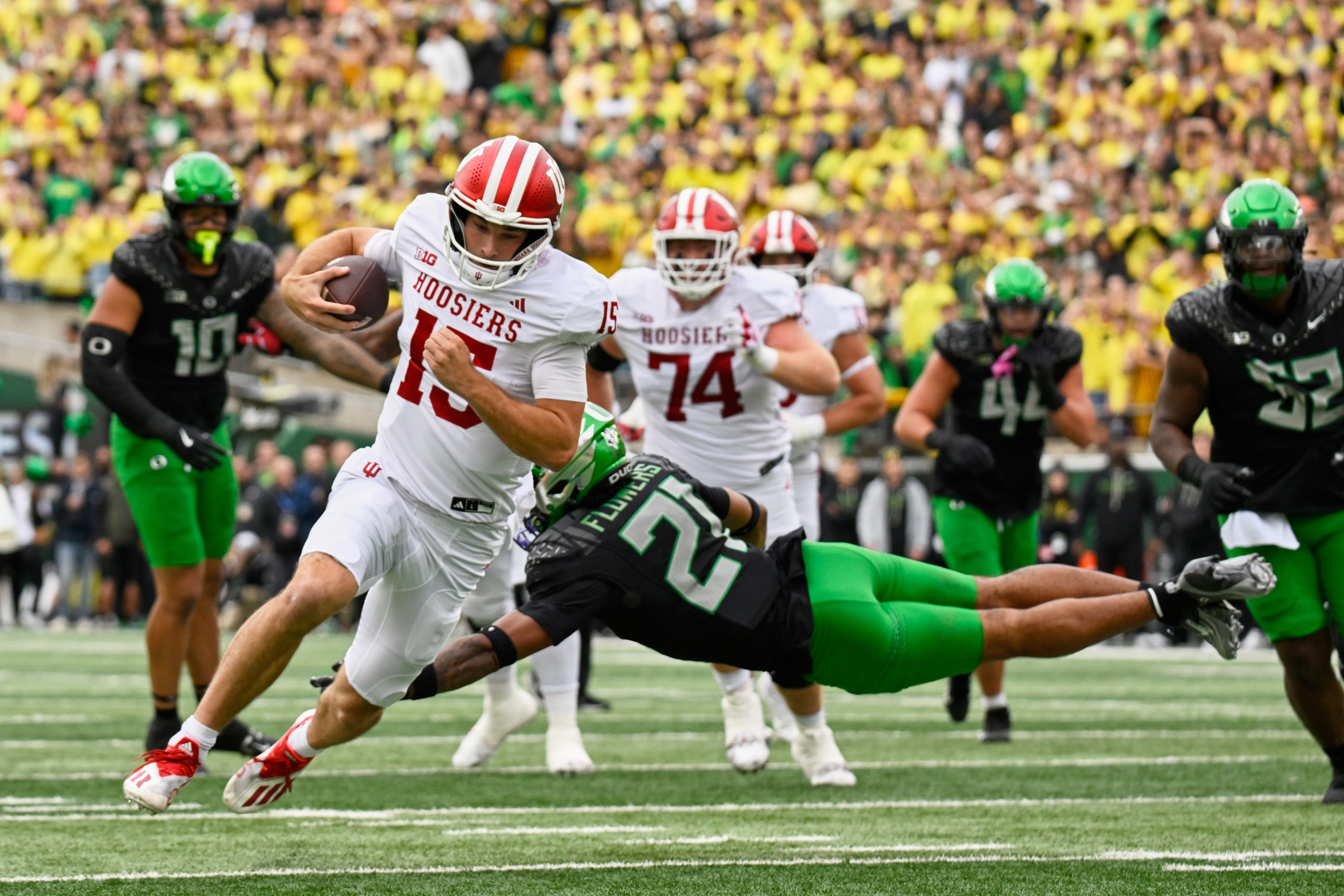 Indiana Hoosiers quarterback Fernando Mendoza (15) runs with the ball against the Oregon Ducks as we break down our College Football Playoff predictions for the CFP semifinals.