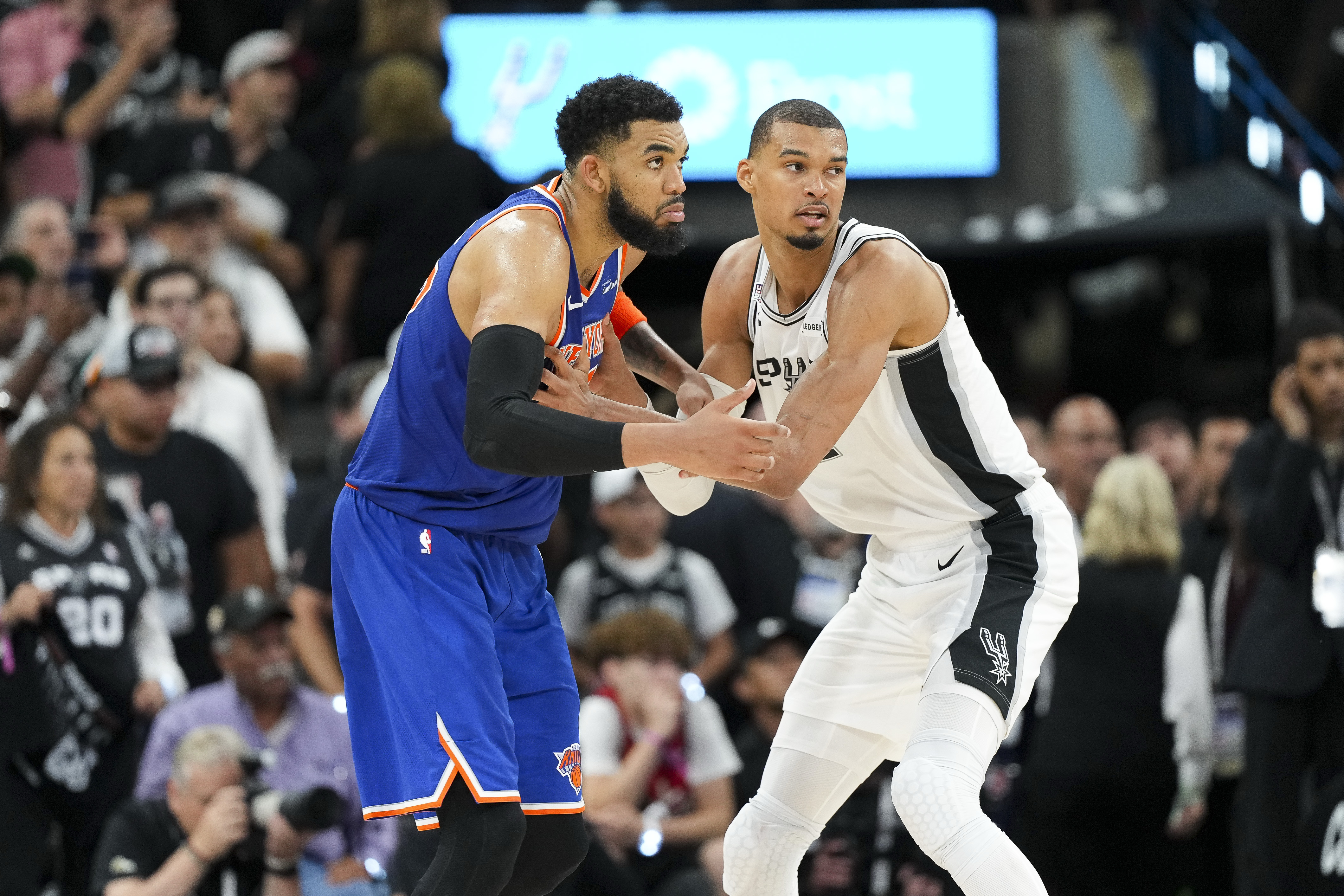 New York Knicks center Karl-Anthony Towns (32) and San Antonio Spurs forward Victor Wembanyama (1) look for the ball during a game, and both are featured in our 2026 NBA Finals MVP odds.