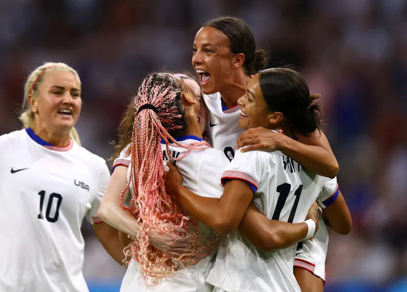 Sophia Smith, Mallory Swanson and Trinity Rodman celebrate a goal as we offer our predictions for the gold medal game between the USA and Brazil.