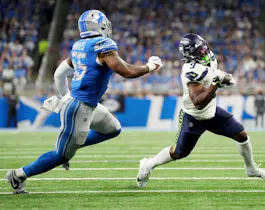 Derrick Barnes of the Detroit Lions chases Kenneth Walker III of the Seattle Seahawks as we share our favorite Seahawks vs. Giants prediction.