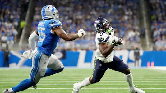 Derrick Barnes of the Detroit Lions chases Kenneth Walker III of the Seattle Seahawks as we share our favorite Seahawks vs. Giants prediction.