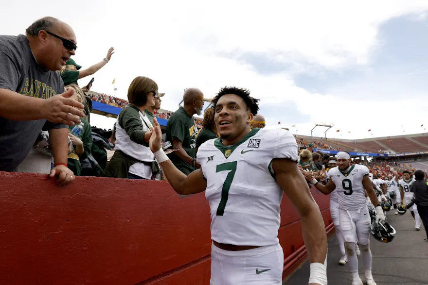 Linebacker Bryson Jackson and defensive lineman TJ Franklin of the Baylor Bears celebrate with Baylor fans after beating Iowa State.