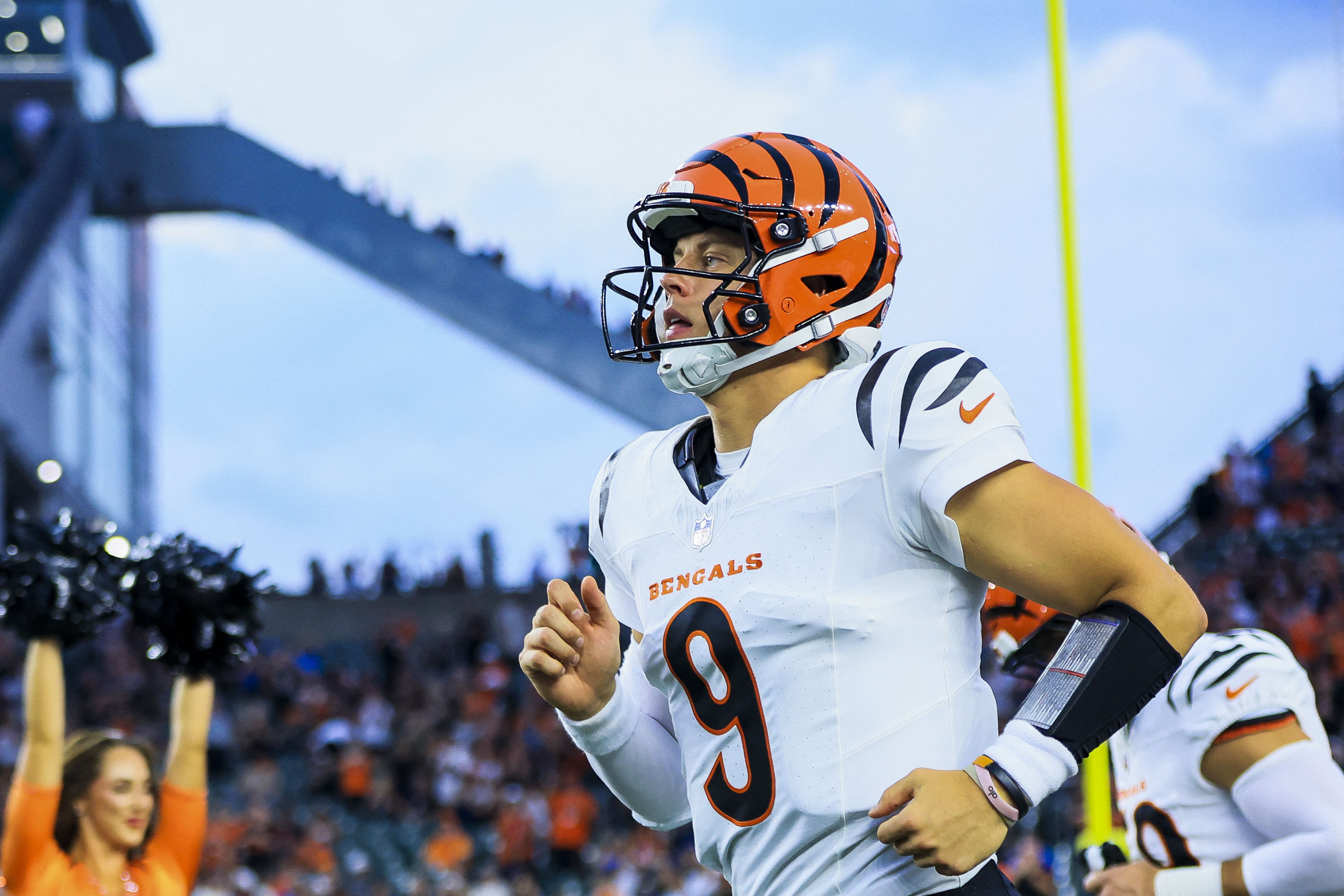 Cincinnati Bengals quarterback Joe Burrow (9) runs onto the field as he is featured in our NFL parlay picks Week 1.