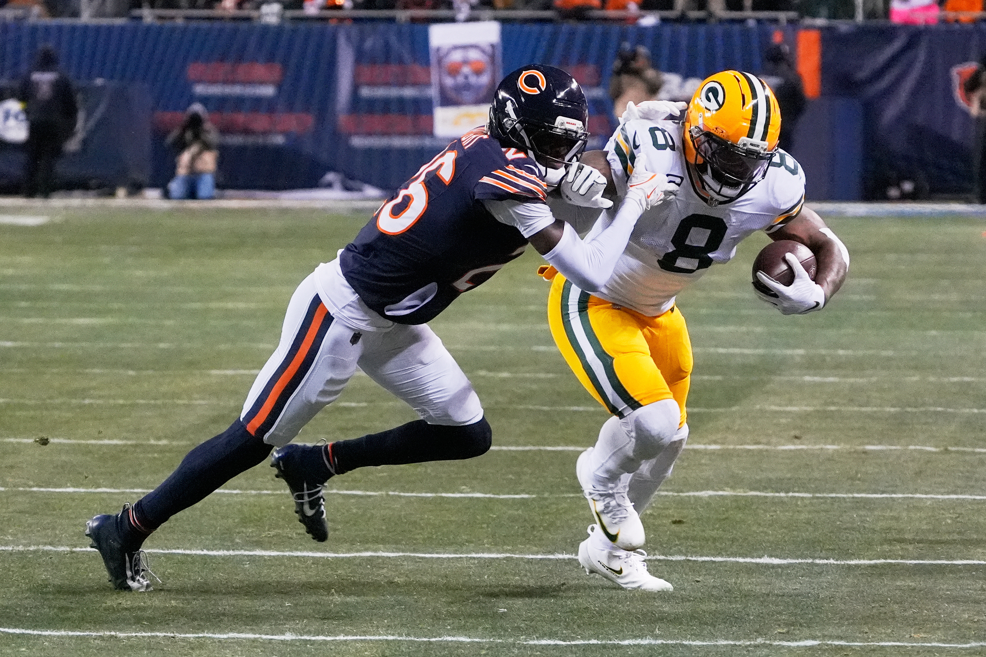 Green Bay Packers running back Josh Jacobs (8) runs with the ball as we break down our Packers vs. Bears expert picks.