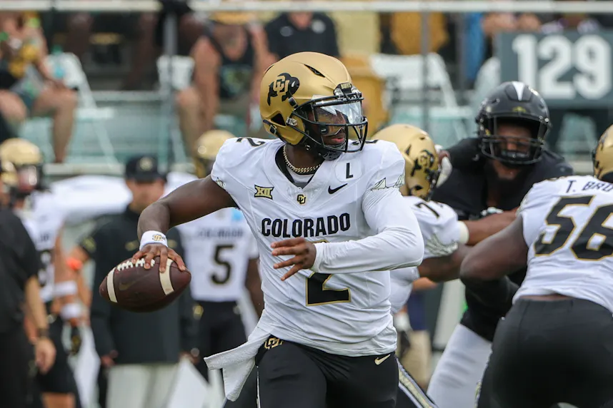 Colorado Buffaloes quarterback Shedeur Sanders rolls out to pass as we look at our Kansas State vs. Colorado player prop bets
