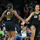 Jackie Young of the Las Vegas Aces is congratulated by teammate A'ja Wilson after Young hit a 3-pointer against the New York Liberty as we look at our Aces-Liberty BetRivers promo code.