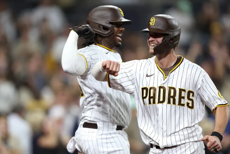 Josh Bell congratulates Wil Myers of the San Diego Padres after his solo homerun during the eighth inning of a game against the San Francisco Giantsat PETCO Park on October 04, 2022 in San Diego, California.
