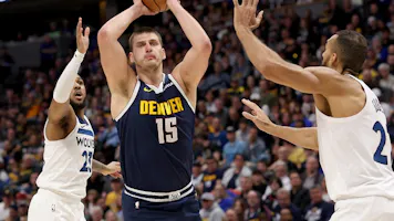 Nikola Jokic (15) of the Denver Nuggets goes to the basket as we offer our best Timberwolves vs. Nuggets player props for Game 1 on Saturday at Ball Arena in Denver.