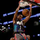 Mikal Bridges of the Brooklyn Nets dunks over Joel Embiid of the Philadelphia 76ers in the first half at the Barclays Center.