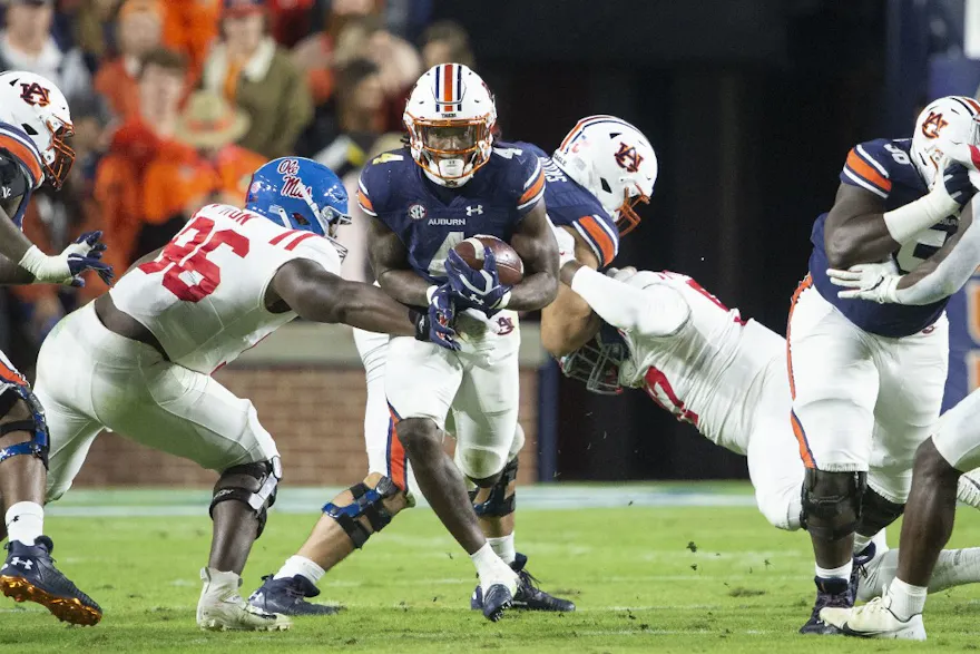 Running back Tank Bigsby of the Auburn Tigers runs the ball by defensive lineman Isaiah Iton of the Mississippi Rebels at Jordan-Hare Stadium on Oct. 30, 2021 in Auburn, Alabama.
