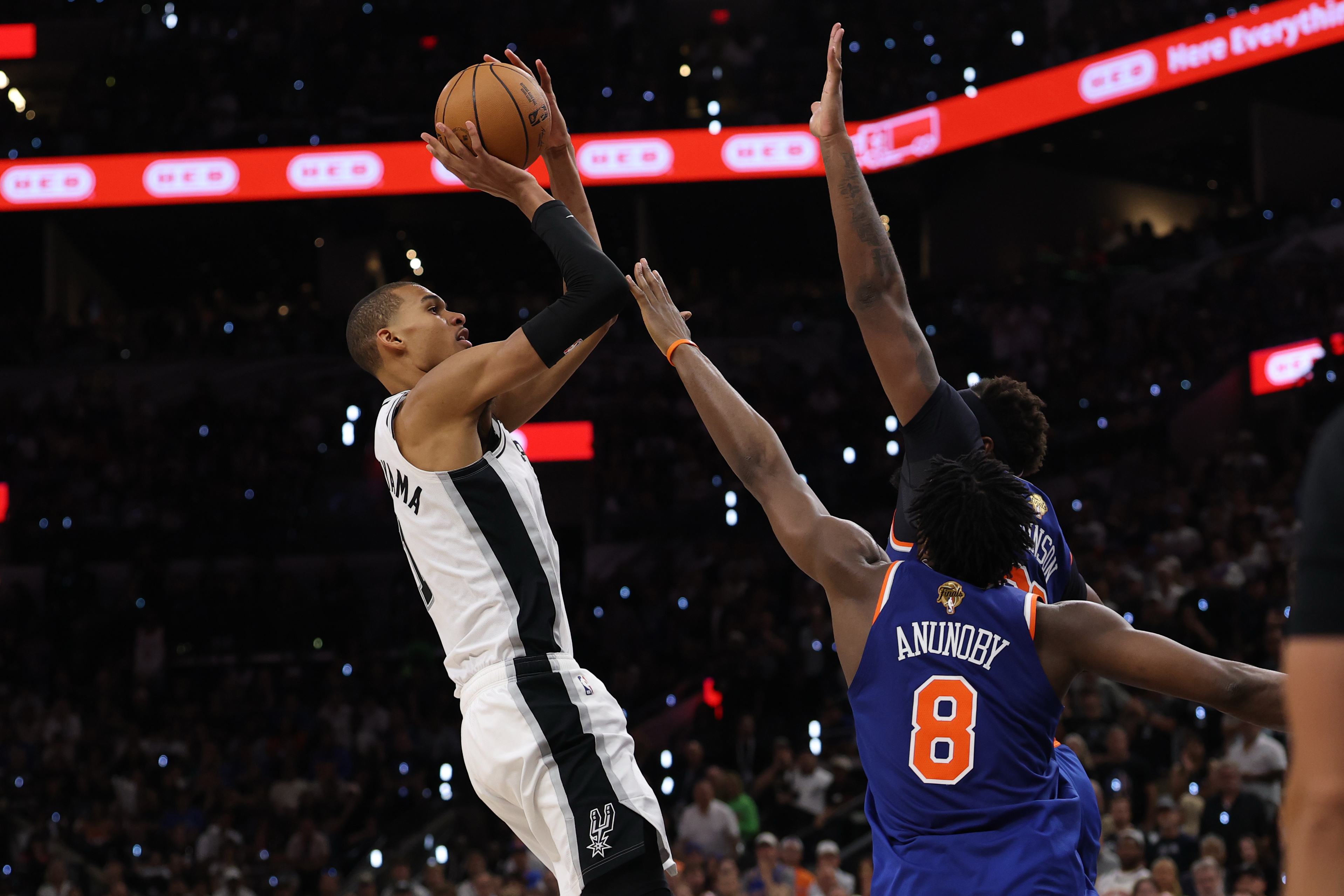 San Antonio Spurs forward Victor Wembanyama (1) shoots as New York Knicks forward Og Anunoby (8) and Knicks center Mitchell Robinson (23) defend as we look at the NBA MVP odds. 