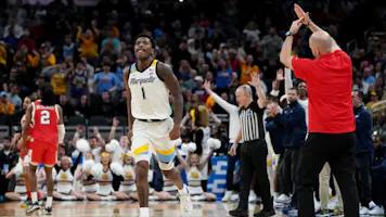 Kam Jones of the Marquette Golden Eagles celebrates a 3-point basket against the Western Kentucky Hilltoppers during the NCAA Men's Basketball Tournament. We're backing Jones in our NC State vs. Marquette expert picks and best bet.