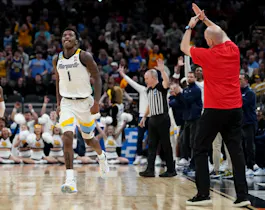 Kam Jones of the Marquette Golden Eagles celebrates a 3-point basket against the Western Kentucky Hilltoppers during the NCAA Men's Basketball Tournament. We're backing Jones in our NC State vs. Marquette expert picks and best bet.
